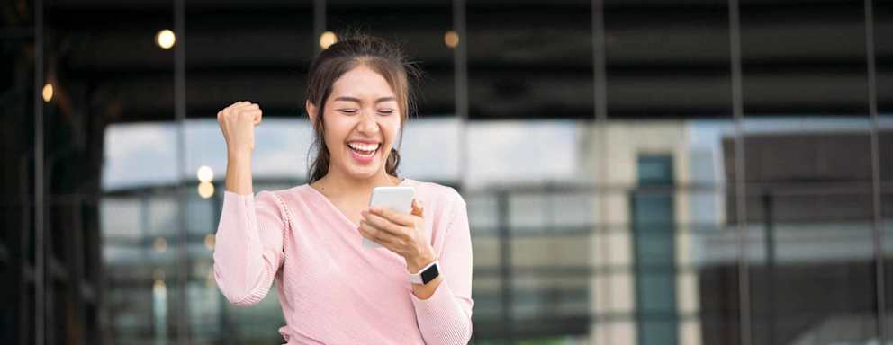 Excited student reading good news on line