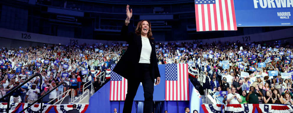 Democratic presidential nominee Kamala Harris excitedly waves at the crowd as she arrives for a campaign rally at the Bojangles Arena on September 12, 2024 in Charlotte, North Carolina.