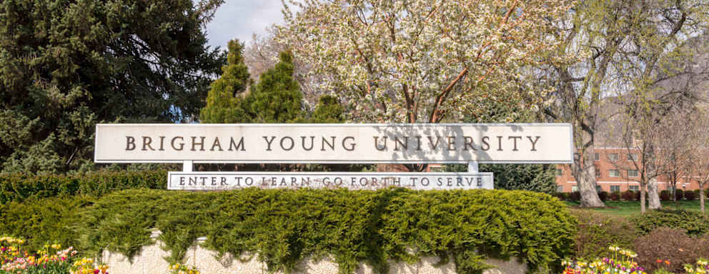 Welcome sign at the entrance to Brigham Young University in Provo, Utah, on a sunny spring day.