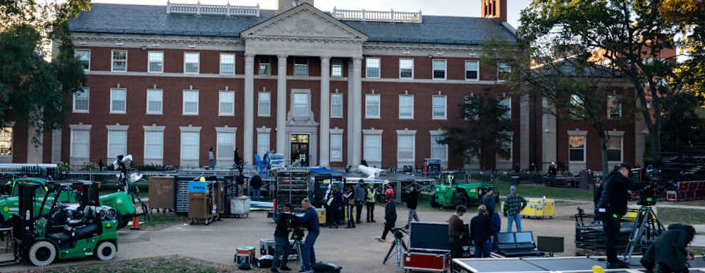 Workers start to build out the Harris-Walz campaign election stage and event space at Howard University