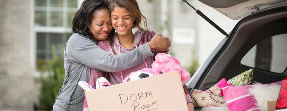 Mom helping daughter move in to dorm room