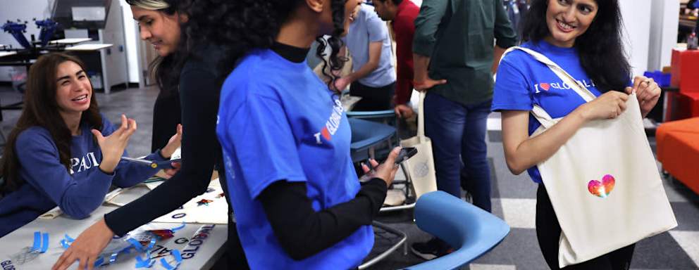 DePaul University students Beemnet Desta of Ethiopia and Suchita Farkiwala of India talk after making tote bags at a social gathering for international students at the school's downtown Chicago campus.