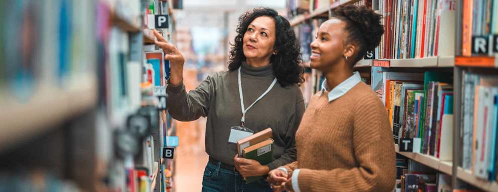 Librarian helps patron find book