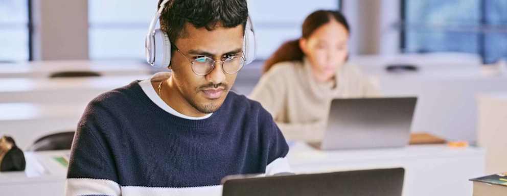 Student in headphones and laptop for classroom education