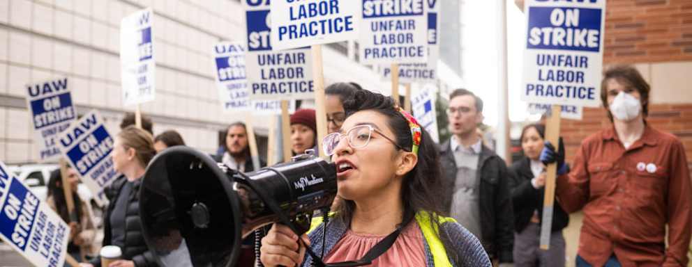Gloria Bartolo, a 2nd year molecular biology PhD student, leads UCLA postdoctoral scholars and academic researchers on a strike through Westwood, Los Angeles, as they demand better wages, student housing, and child care from the University of California on December 1, 2022.