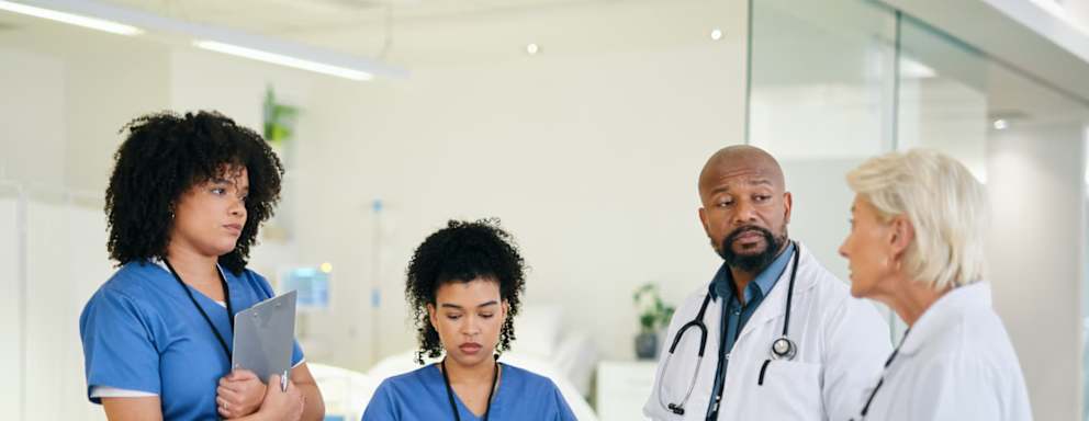 Nurses taking notes on clipboards in a hospital