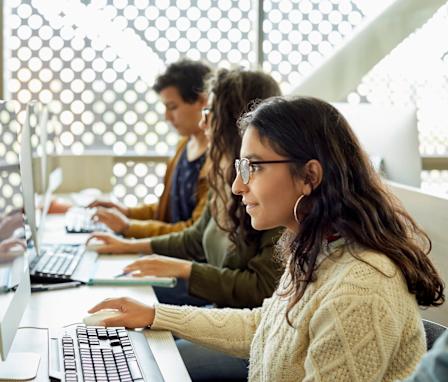 Students typing on computers in class