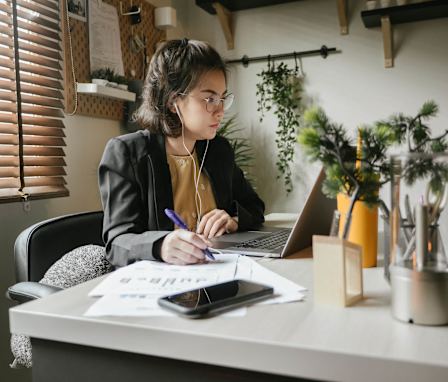 Accounting student working at desk on laptop