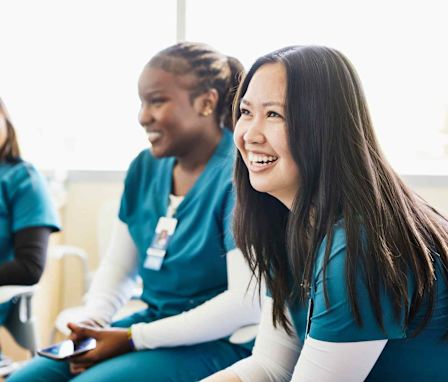 Nurses sitting and laughing together