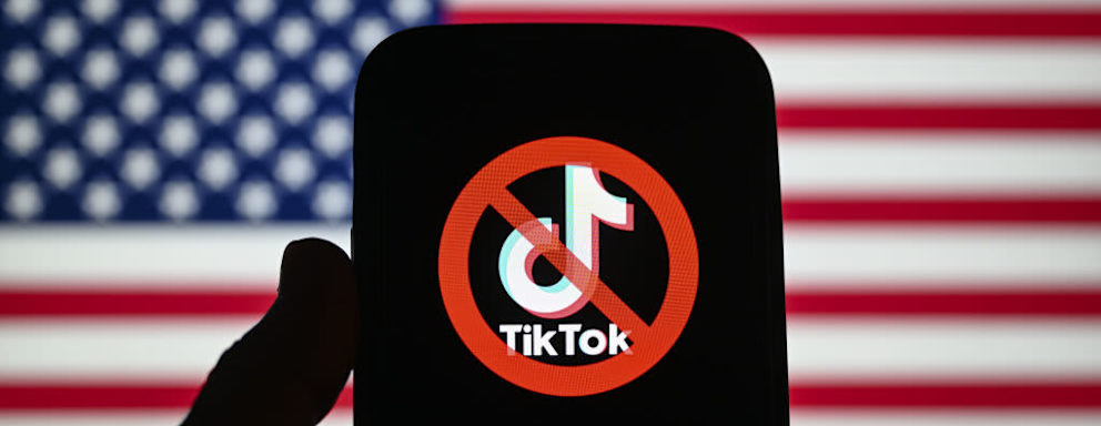 WASHINGTON D.C., UNITED STATES - MARCH 15: In this photo illustration, logo of TikTok is displayed on mobile phone screen in front of American Flag in Washington DC, United States on March 15, 2023. (Photo by Celal Gunes/Anadolu Agency via Getty Images)