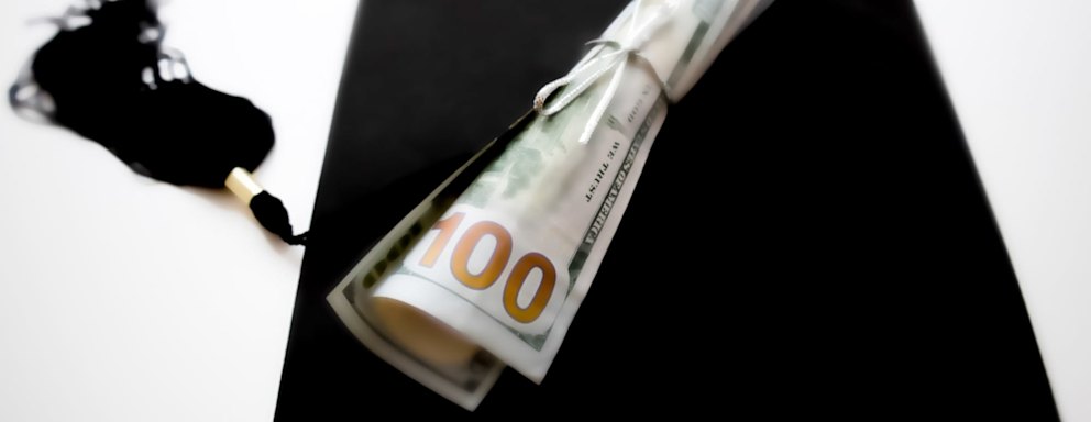 school diploma wrapped in $100 bills &amp; traditional black graduation cap with tassel