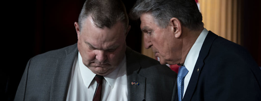 US Senator Joe Manchin, a Democrat from West Virginia, speaks to Senator Jon Tester, a Democrat from Montana, during a news conference about a bill to ban Russian energy imports at the US Capitol in Washington, DC.
