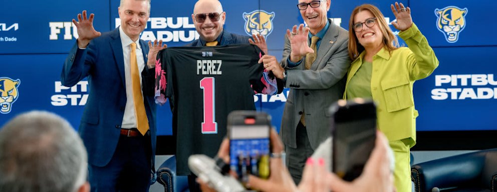 Scott Carr, Pitbull, Kenneth Jessell, and Lucy Benedetti pose during the FIU Pitbull Stadium announcement at Tamiami Hall on the Florida International University campus on August 6, 2024 in Miami, Florida.