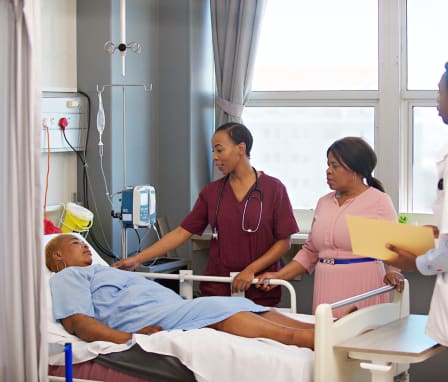 Female doctor comforting patient and friend in a hospital