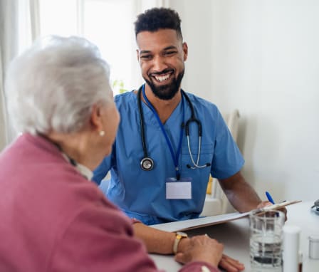 Medical assistant talking to patient about health history