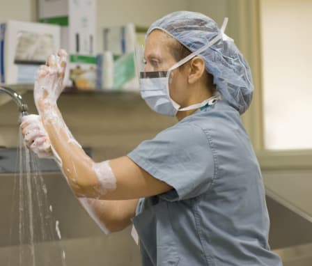 Surgical nurse scrubbing hands