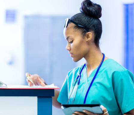 Nurse checking clipboard in emergency room