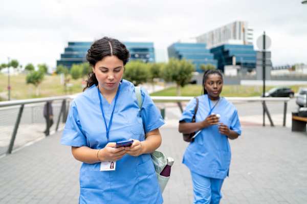 Strike nurses walking outside of a hospital