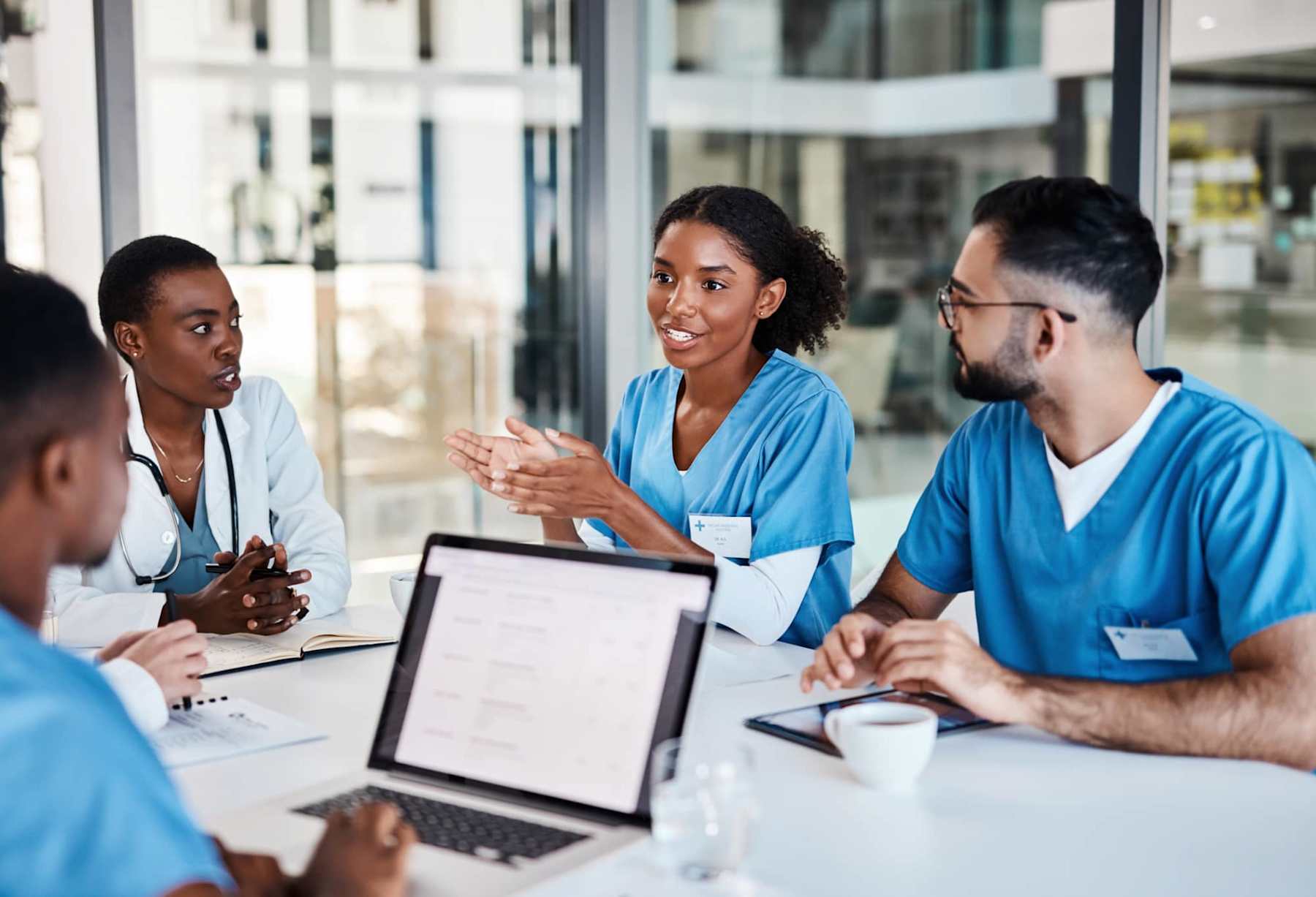 Nurses in a meeting together around a table