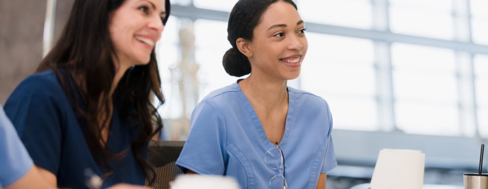 Female nursing students smile during lecture