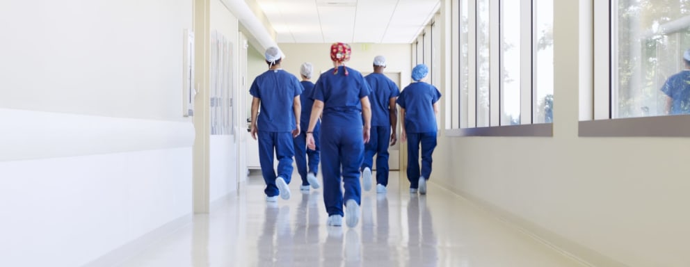 Nurses walking down hospital hallway together