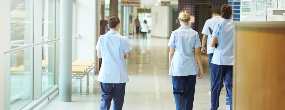 Nurses walking out of a hospital