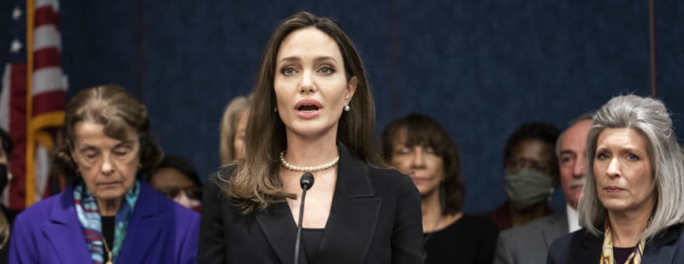 Angelina Jolie speaking on stage at an event