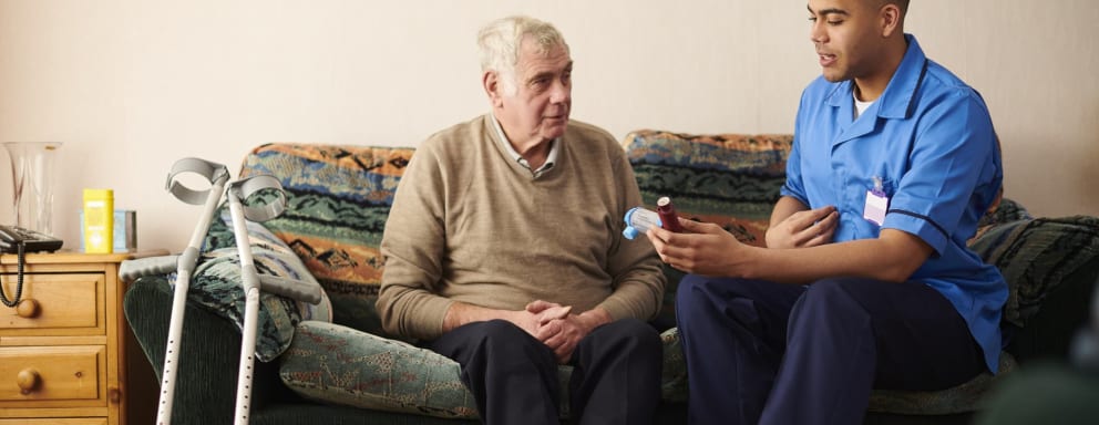 Nurse helping a patient at home