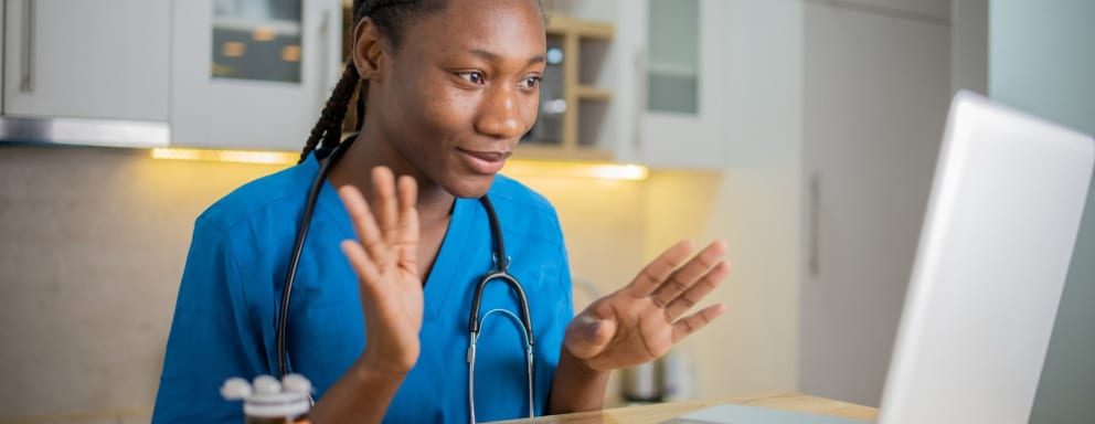 Nurse on video call explaining medication to patient