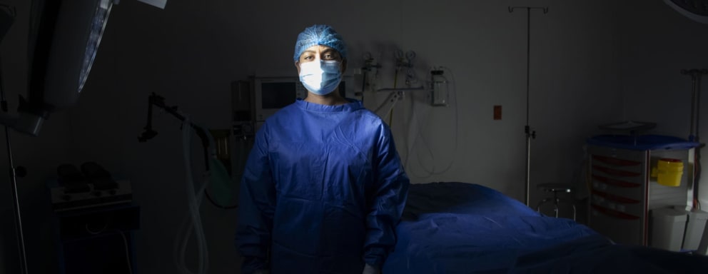 Nurse standing in dark hospital room