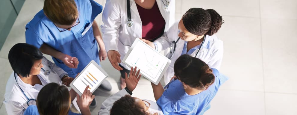 Overhead view of seven medical team members collaborating