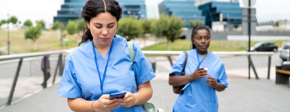 Strike nurses walking outside of a hospital