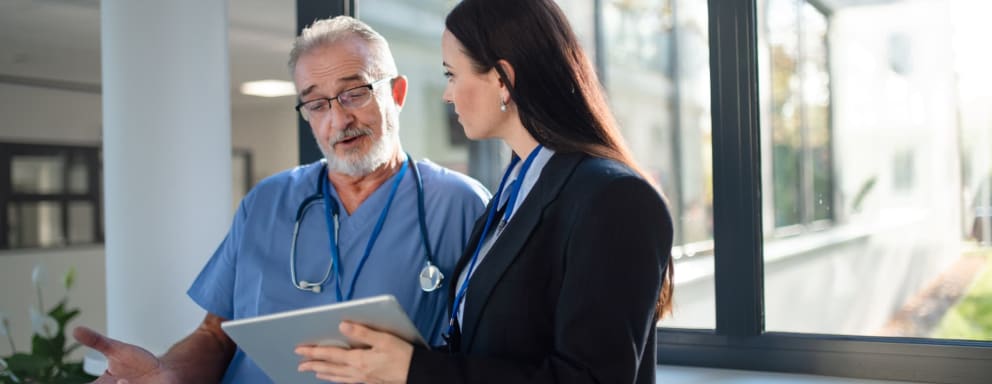 Hospital administrator speaking to doctor