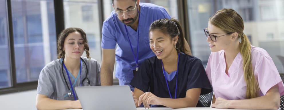 Nurses working on laptop together