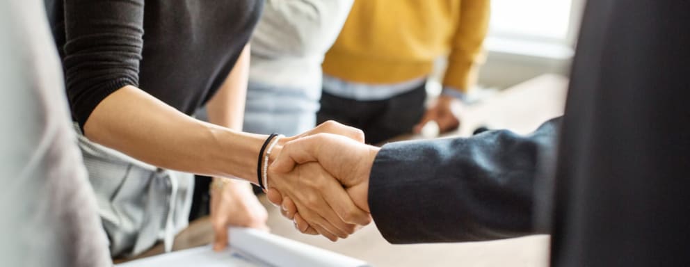 Nursing students shaking hands with lawyer