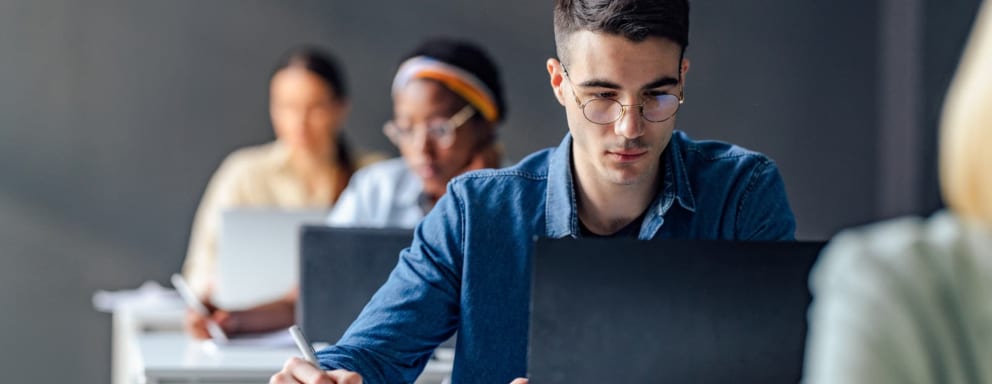 Students taking an entrance exam on laptops