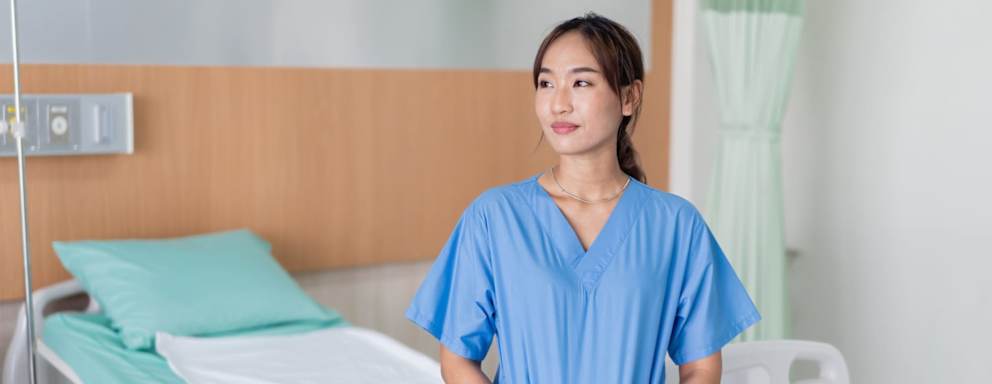 Nurse standing in empty hospital room