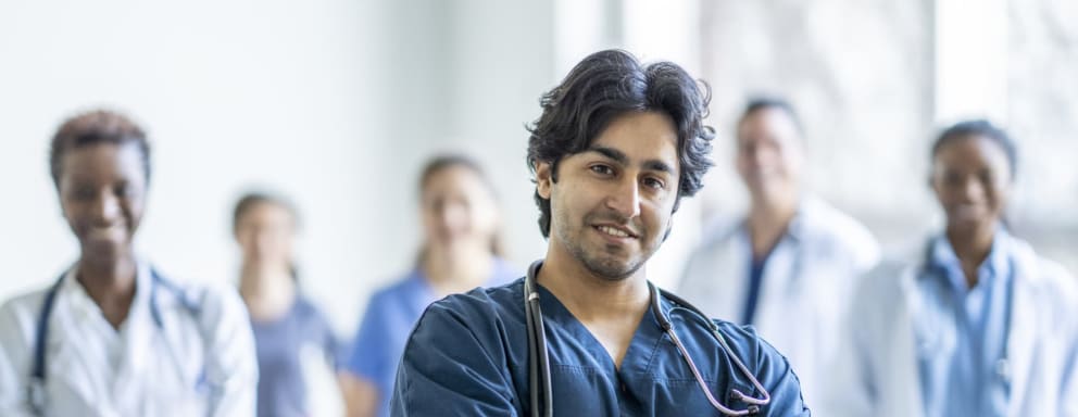 Male nurse standing with the rest of a medical team