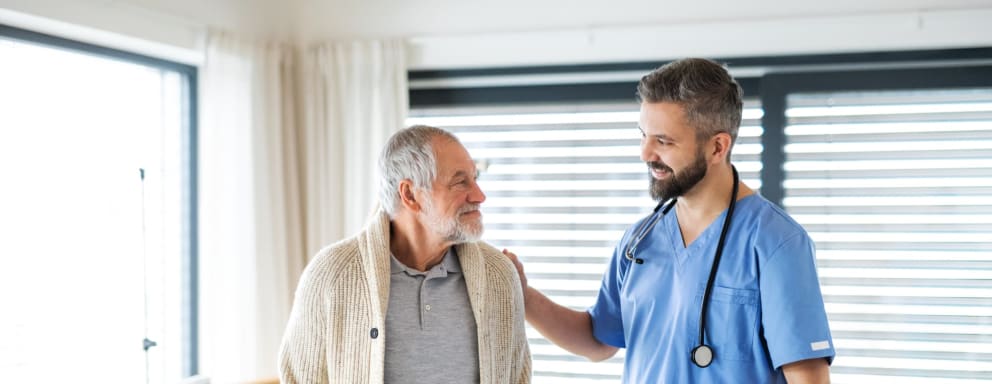 Nurse comforting older patient