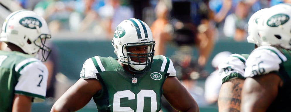 D'Brickashaw Ferguson of the NY Jets standing on the field at a football game