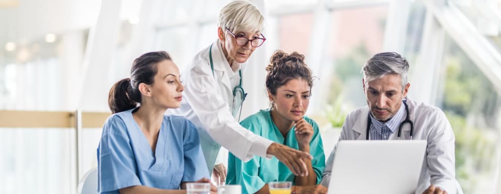 Medical team looking at laptop together