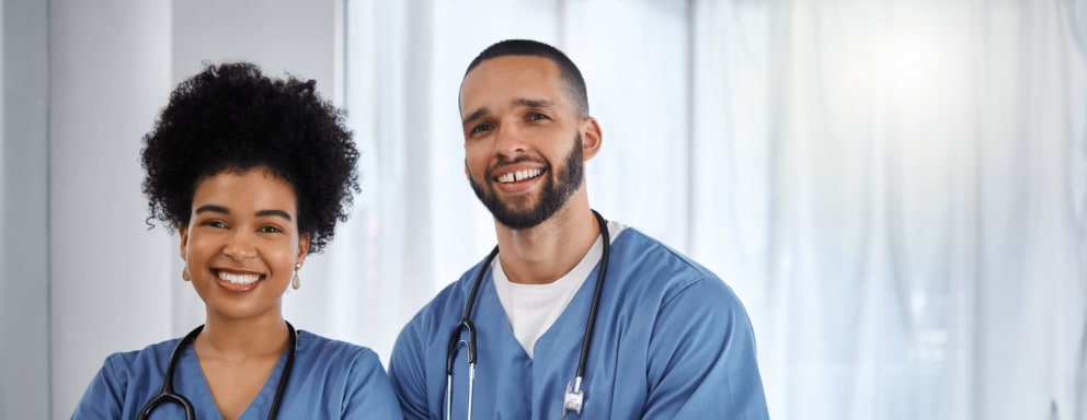 Two happy nurses in a hospital room