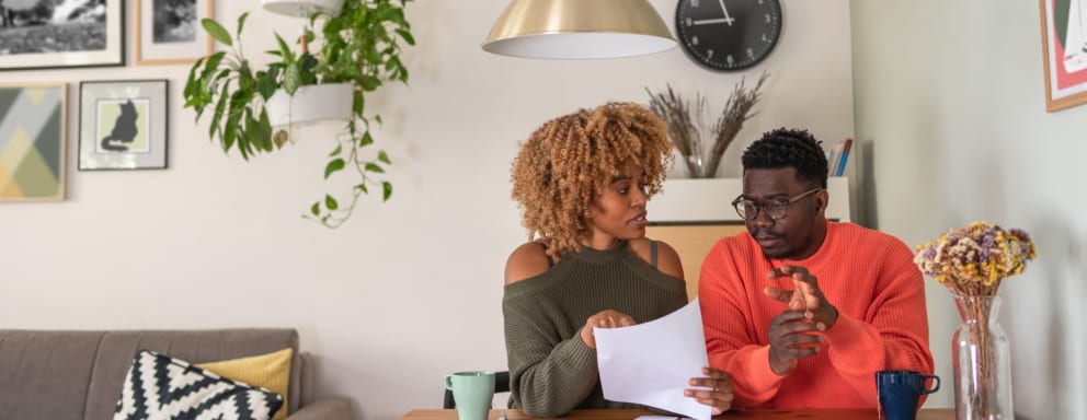 Couple filling out healthcare paperwork at home