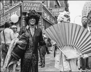 Portrait of American gay liberation activist Marsha P Johnson along with unidentified others, on the corner of Christopher Street and 7th Avenue during the Pride March New York, New York, June 27, 1982.