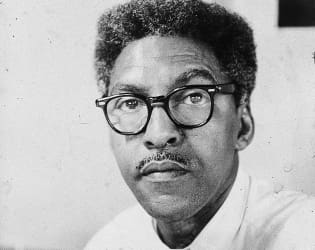 Bayard Rustin, civil rights activist, sitting in his office.