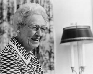 A black and white photo of Dr. Virginia Apgar smiling.