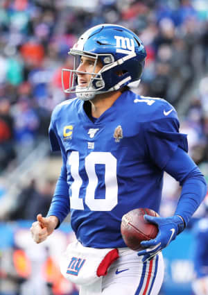 Eli Manning runs off the field after throwing a touchdown in the second quarter of the game between the New York Giants and the Miami Dolphins on December 15, 2019.
