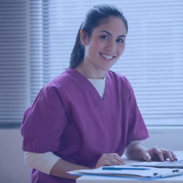 Nurse working at desk in doctor's office