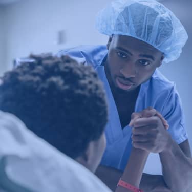 nurse holding patient's hand