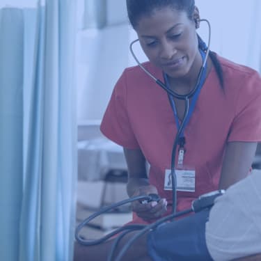 Nurse taking patient's blood pressure